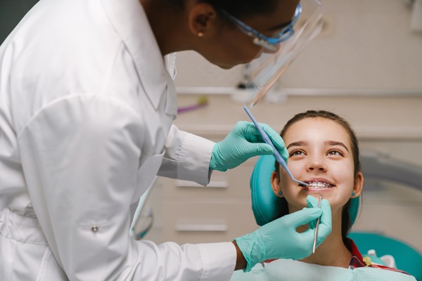 Should I Take My Child To A Kid Friendly Dentist In Dumont For White Spots On Teeth?